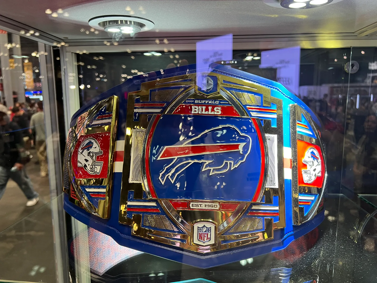 An officially licensed Buffalo Bills championship belt in a display case.