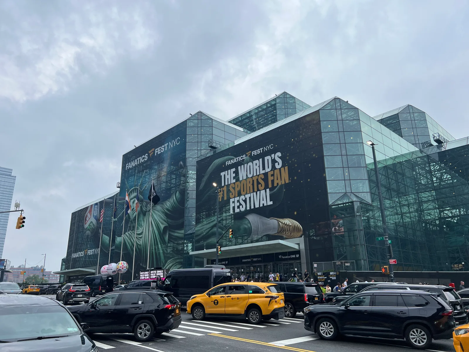 The Javits Center exterior with large Fanatics Fest NYC signs in the rain.